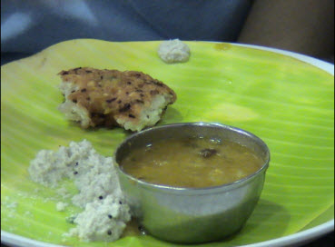 Someone finishing off a vadai